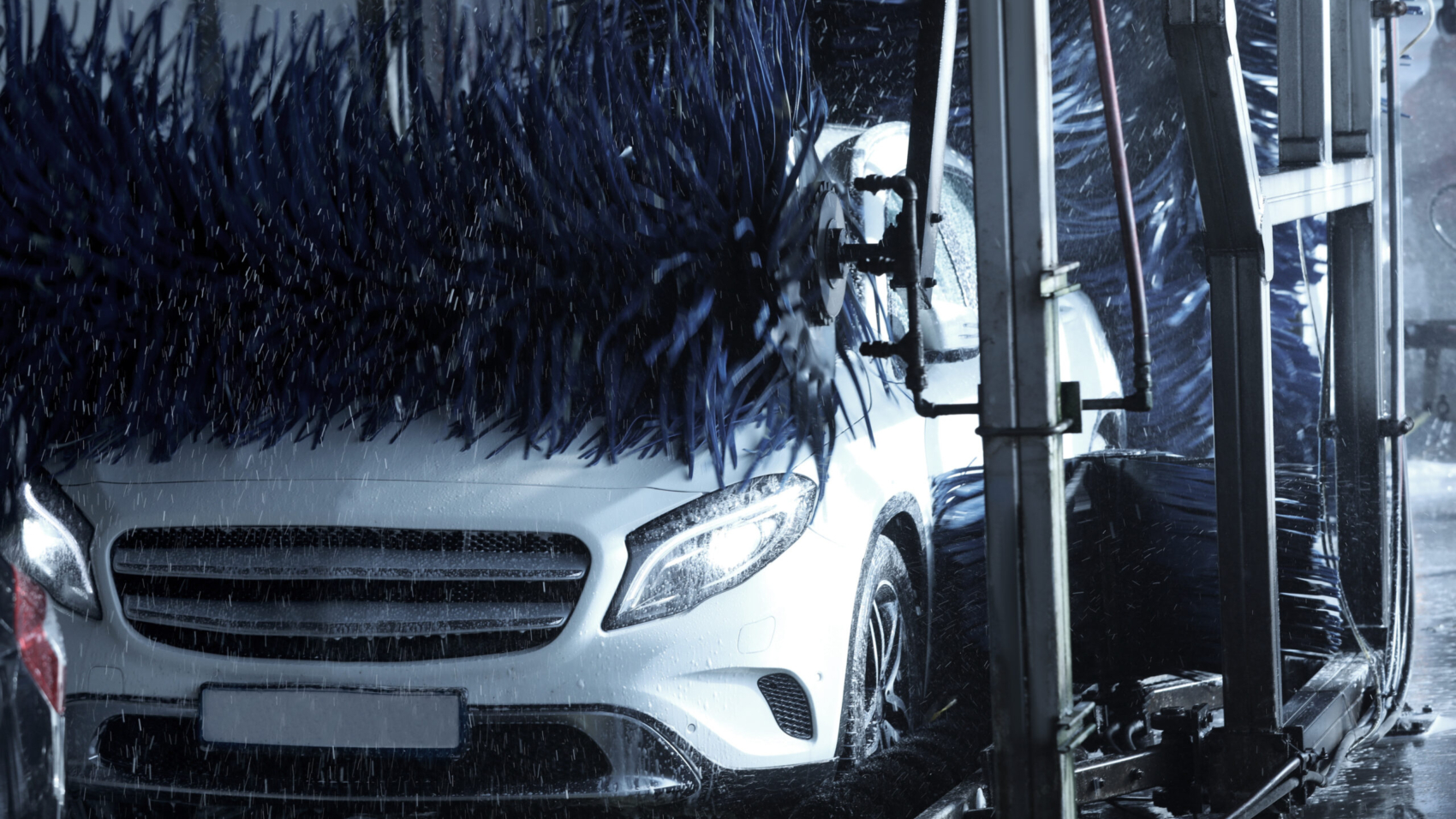 Modern auto undergoing cleaning at car wash